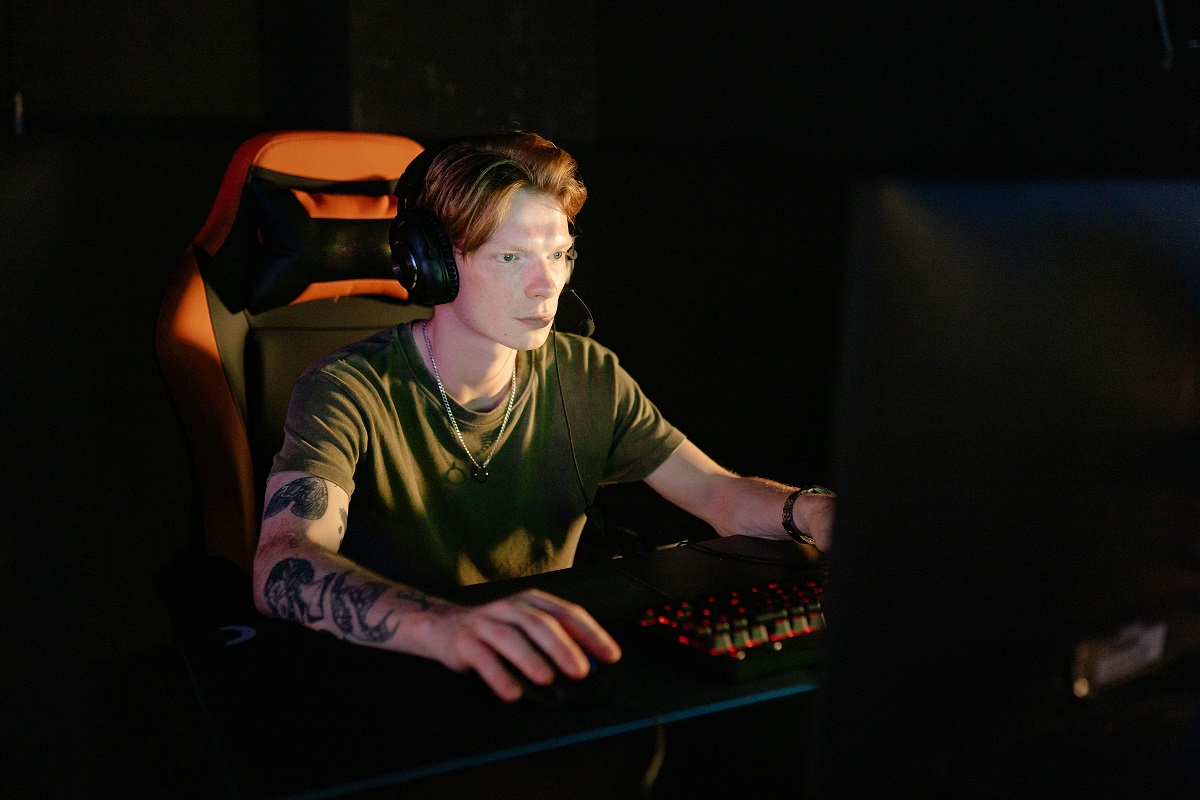 young gamer frowning at a desktop computer